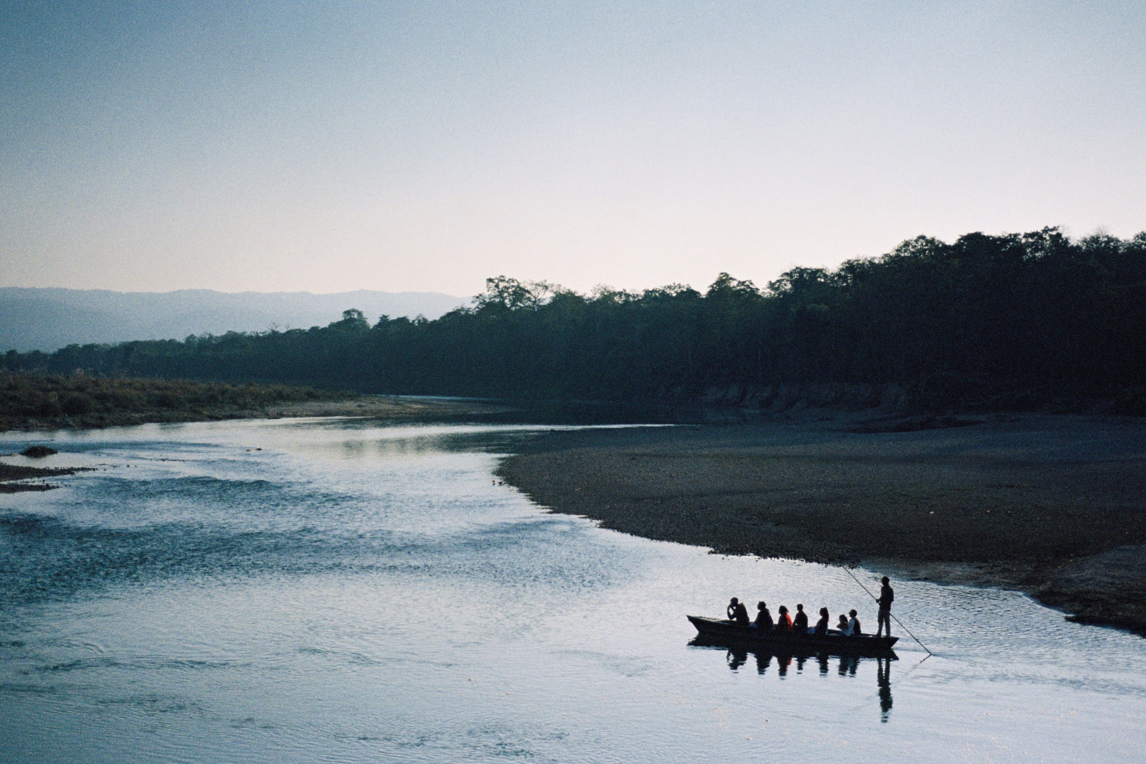 Boat travelling along a river in Chitwan